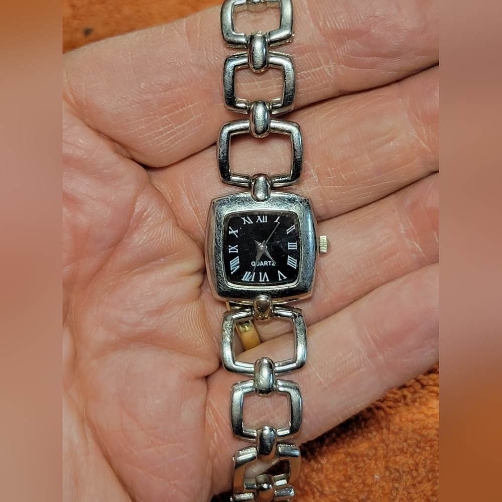 Elegant ladies watch, classic black and silver combination. Works